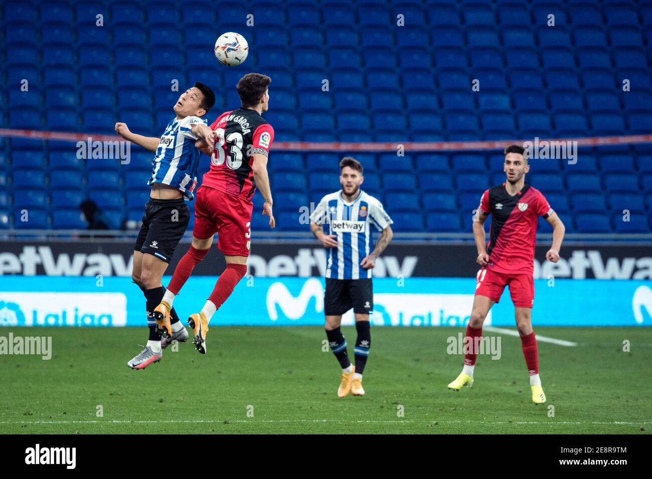Cornella, Spain. 31st Jan, 2021. Espanyol's Wu Lei (1st L) vies with Vallecano's Fran Garcia (2nd L) during a Spanish second division league match between RCD Espanyol and Rayo Vallecano in Cornella, Spain, on Jan. 31, 2021. Credit: Joan Gosa/Xinhua/Alamy Live News Stock Photo