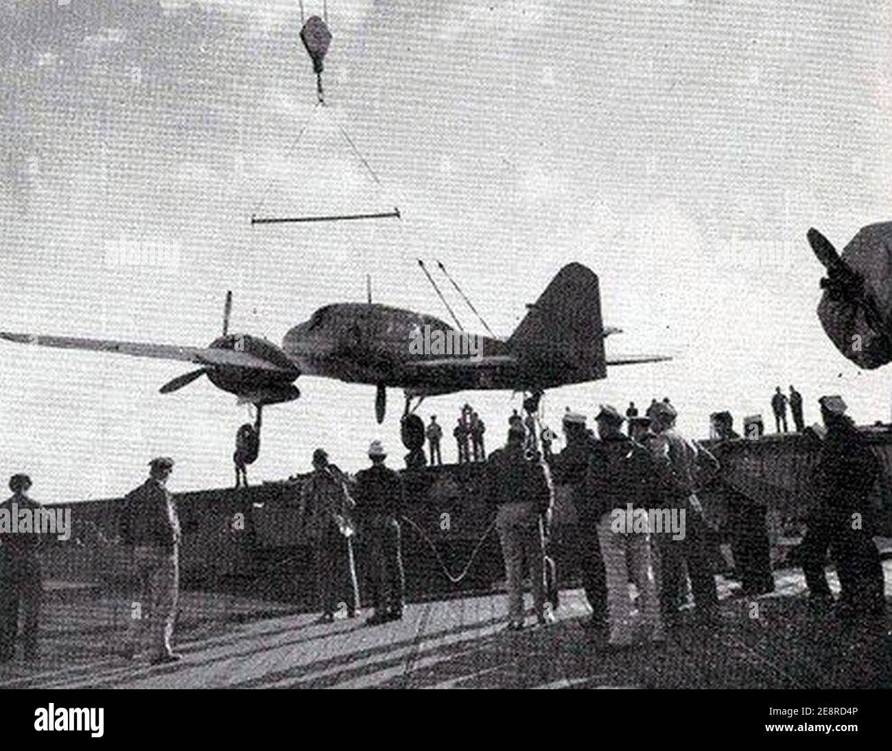 Mitsubishi Ki-46 is loaded on USS Attu (CVE-102) 1944. Stock Photo