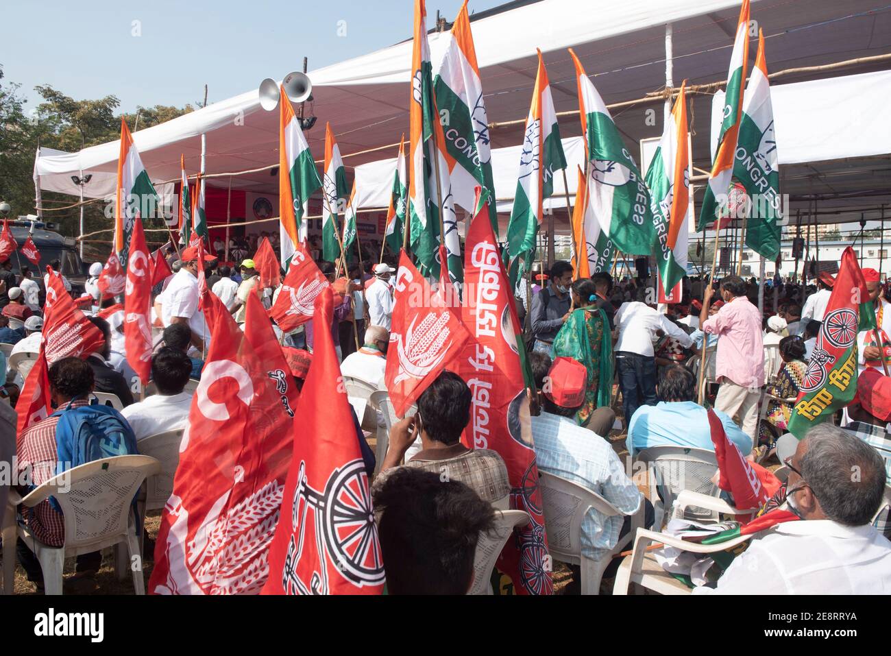 Mumbai , India - 25 January 2021, Farmers activists People hold up flags sitting near pandal in a rally at the Azad Maidan in south Mumbai on Monday a Stock Photo