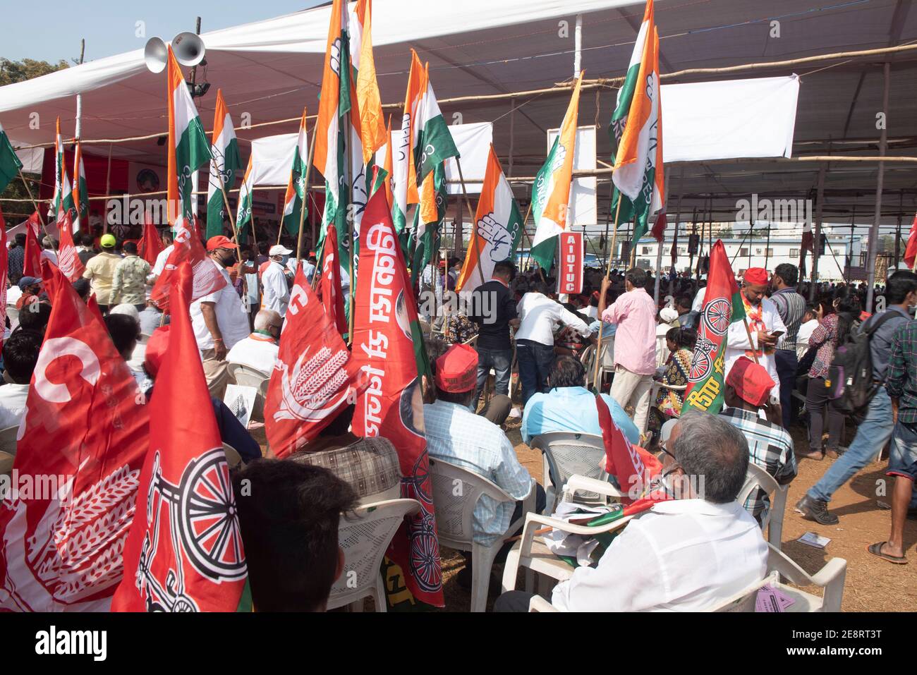 Mumbai , India - 25 January 2021, Farmers activists People hold up flags sitting near pandal in a rally at the Azad Maidan in south Mumbai on Monday a Stock Photo