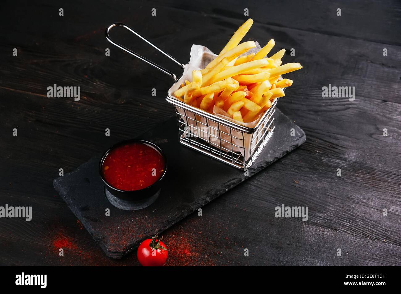 Some french fries ready to be eaten and some sauce un a container Stock Photo Alamy