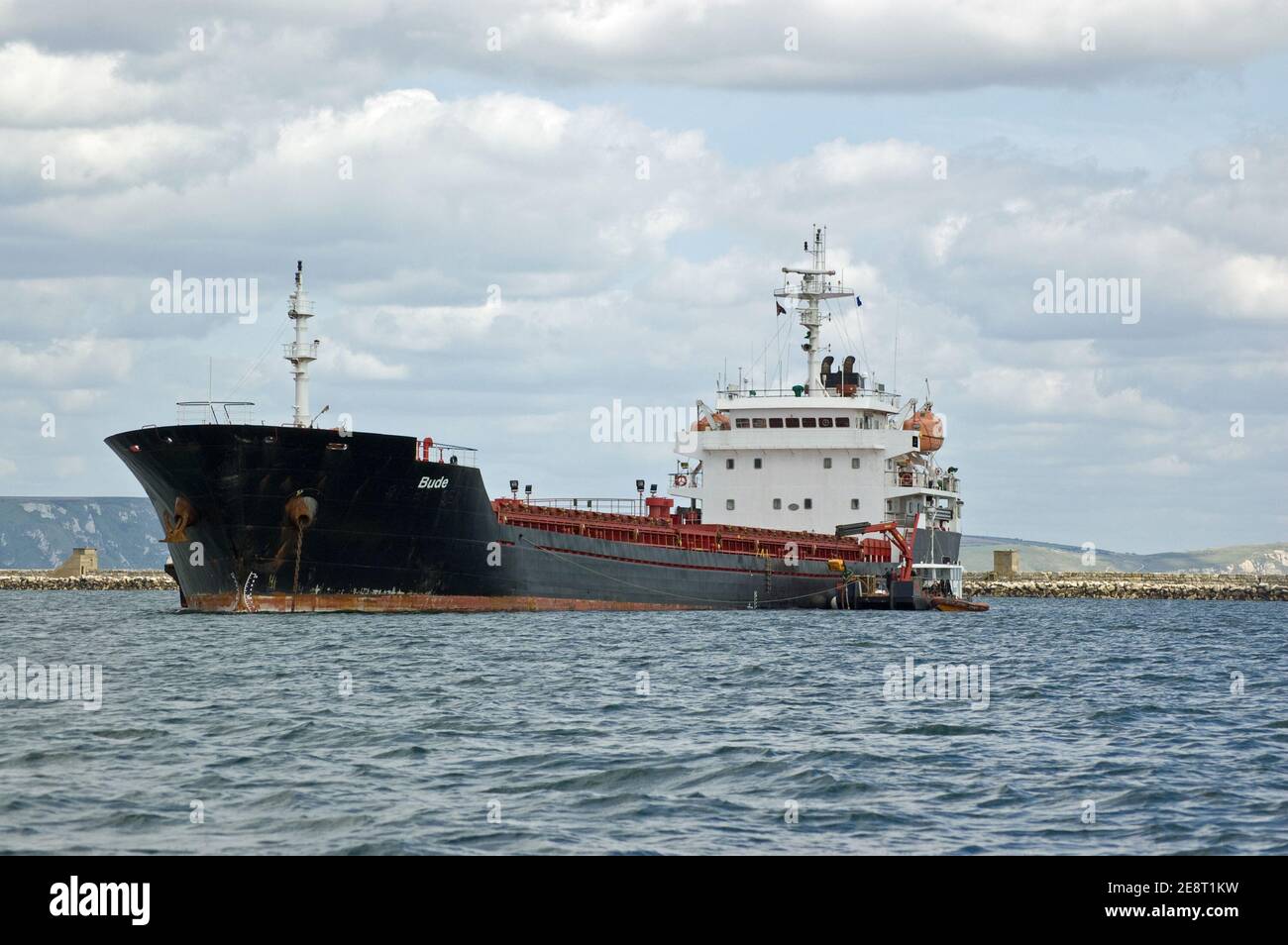 PORTLAND, DORSET, ENGLAND - AUGUST 31: Bulk carrier Bude at anchor in Portland Harbour on August 31 2012. The ship carries vital supplies around Europ Stock Photo