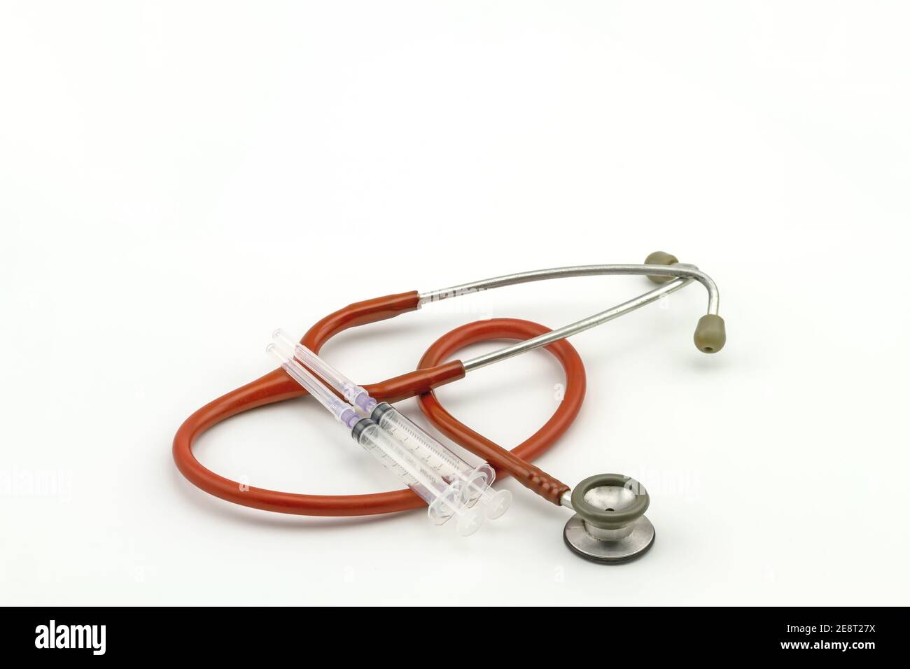 Pink stethoscope and disposable syringe on white background Stock Photo ...