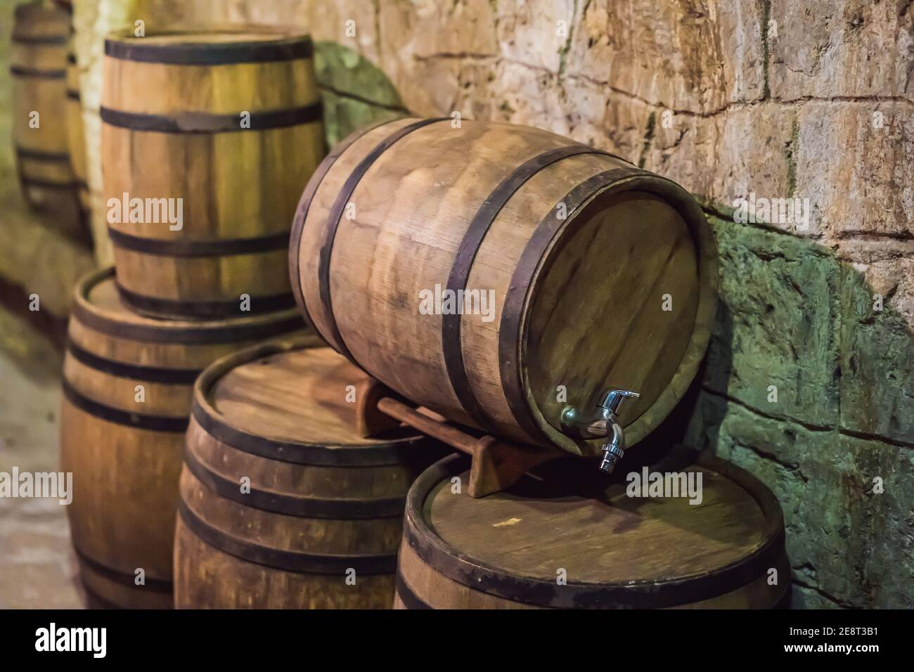 Wine barrels stacked in the old cellar of the winery Stock Photo - Alamy
