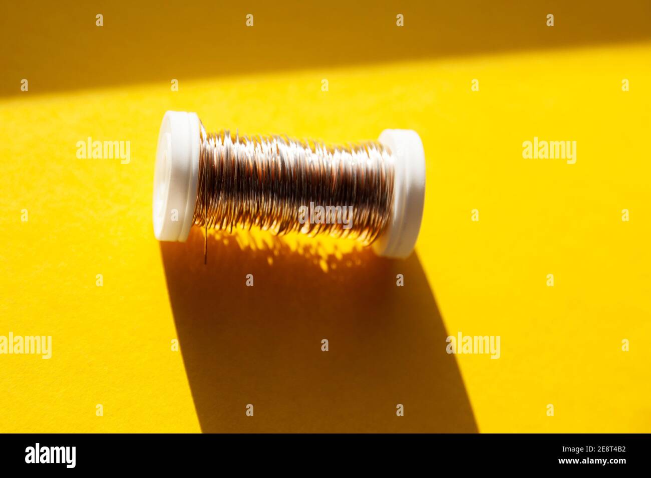 copper wire on small plastic spool Stock Photo