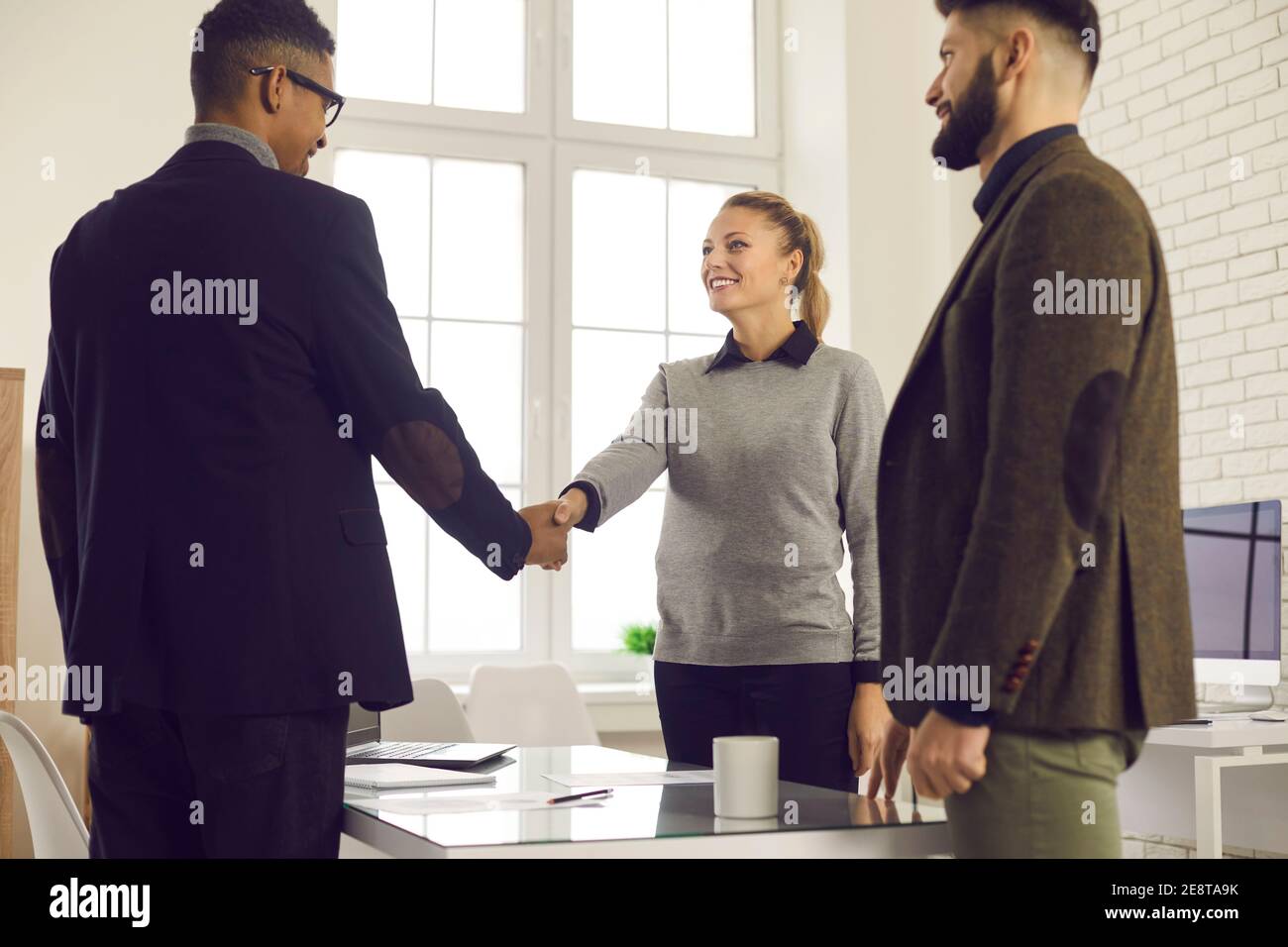 Company manager shaking hands with client, thanking him for trust and collaboration Stock Photo