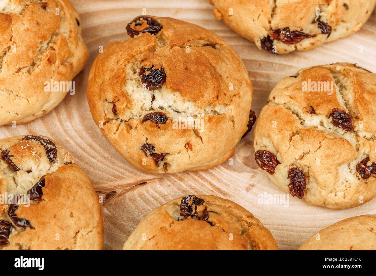 Plenty of raisin cookies on a wooden plate background, detailed view Stock Photo