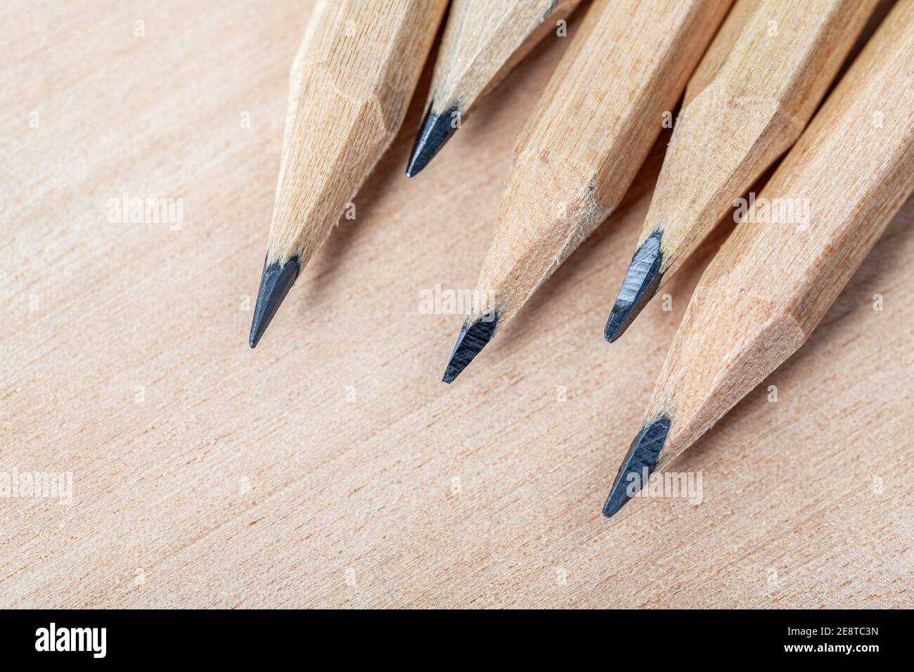 Sharpened pencils on a wooden background Stock Photo