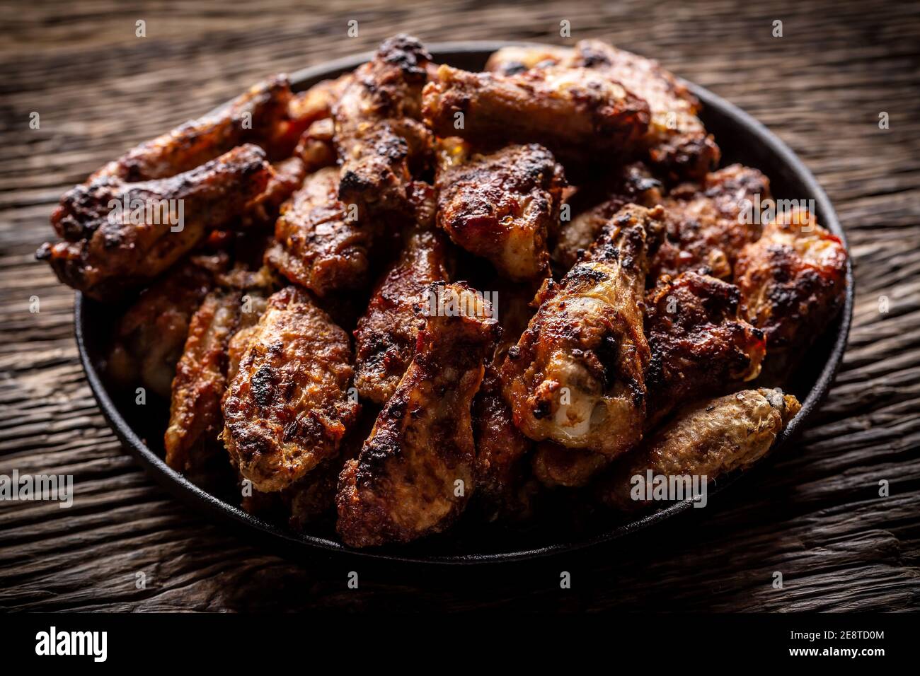 Chicken wings barbeque in a cast iron baking dish Stock Photo