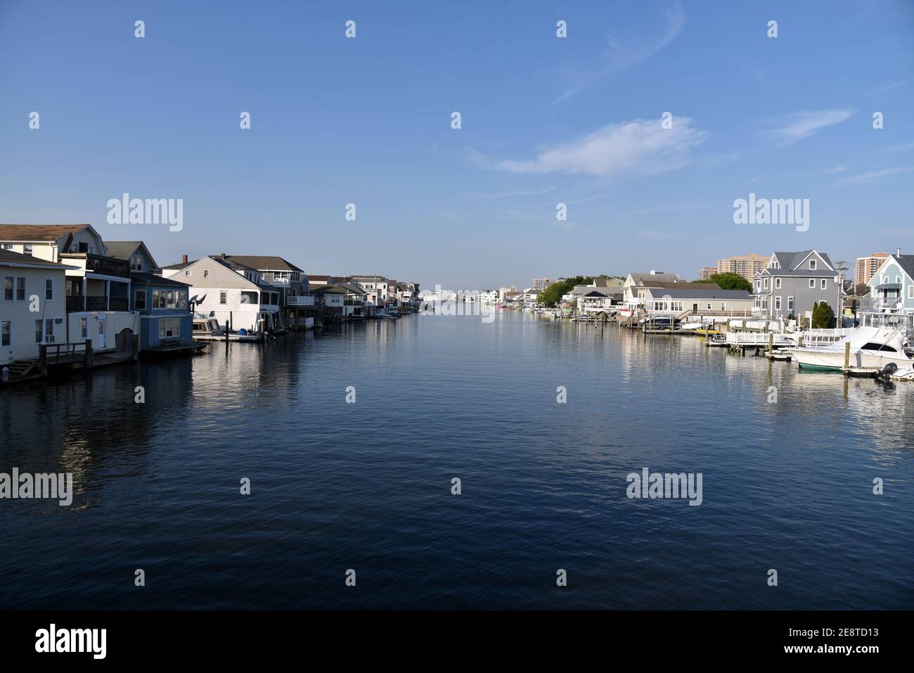 Luxury homes and boats line a beautiful, peaceful waterway near