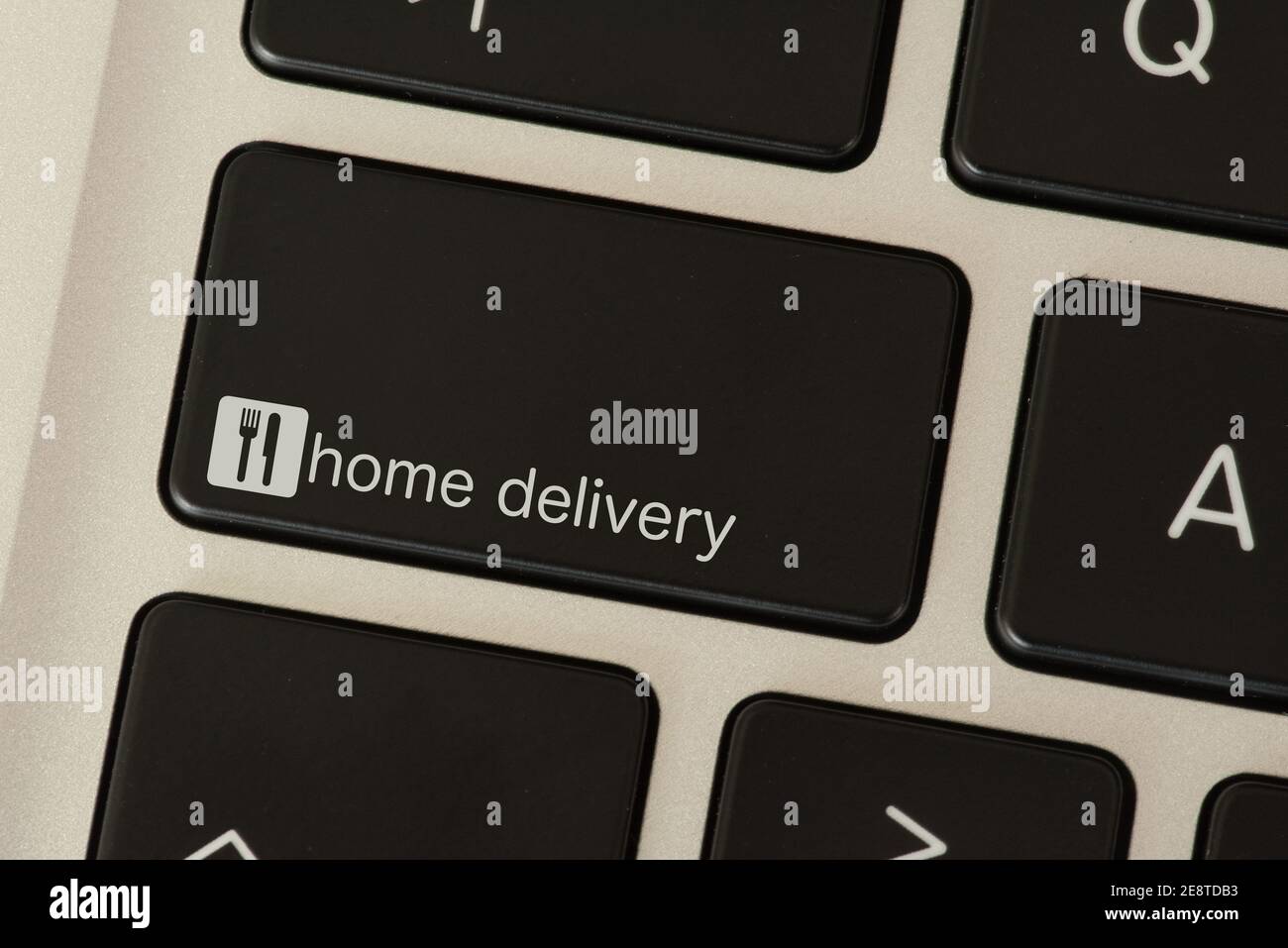 Computer and key for food delivery service Stock Photo