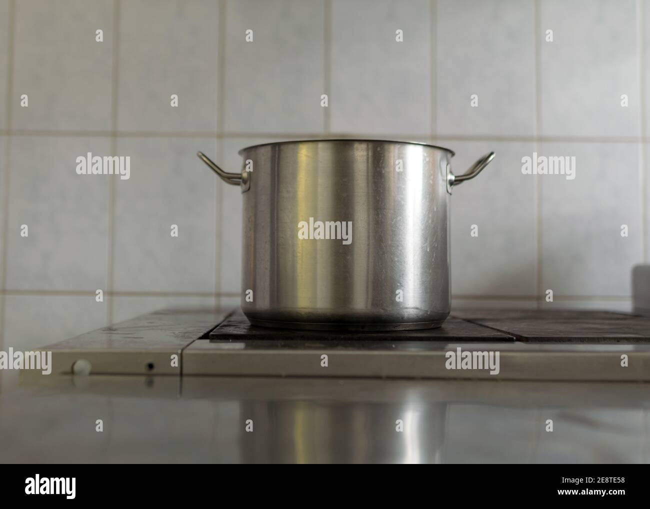 metal pot on the stove top, school kitchen, eat cooking concept Stock Photo
