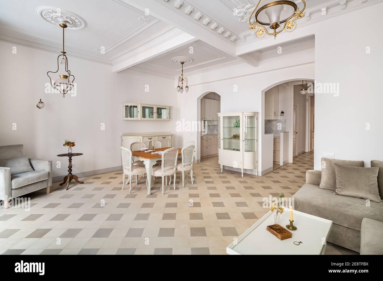 Living room decorated in retro style, with dining table, tile floor and