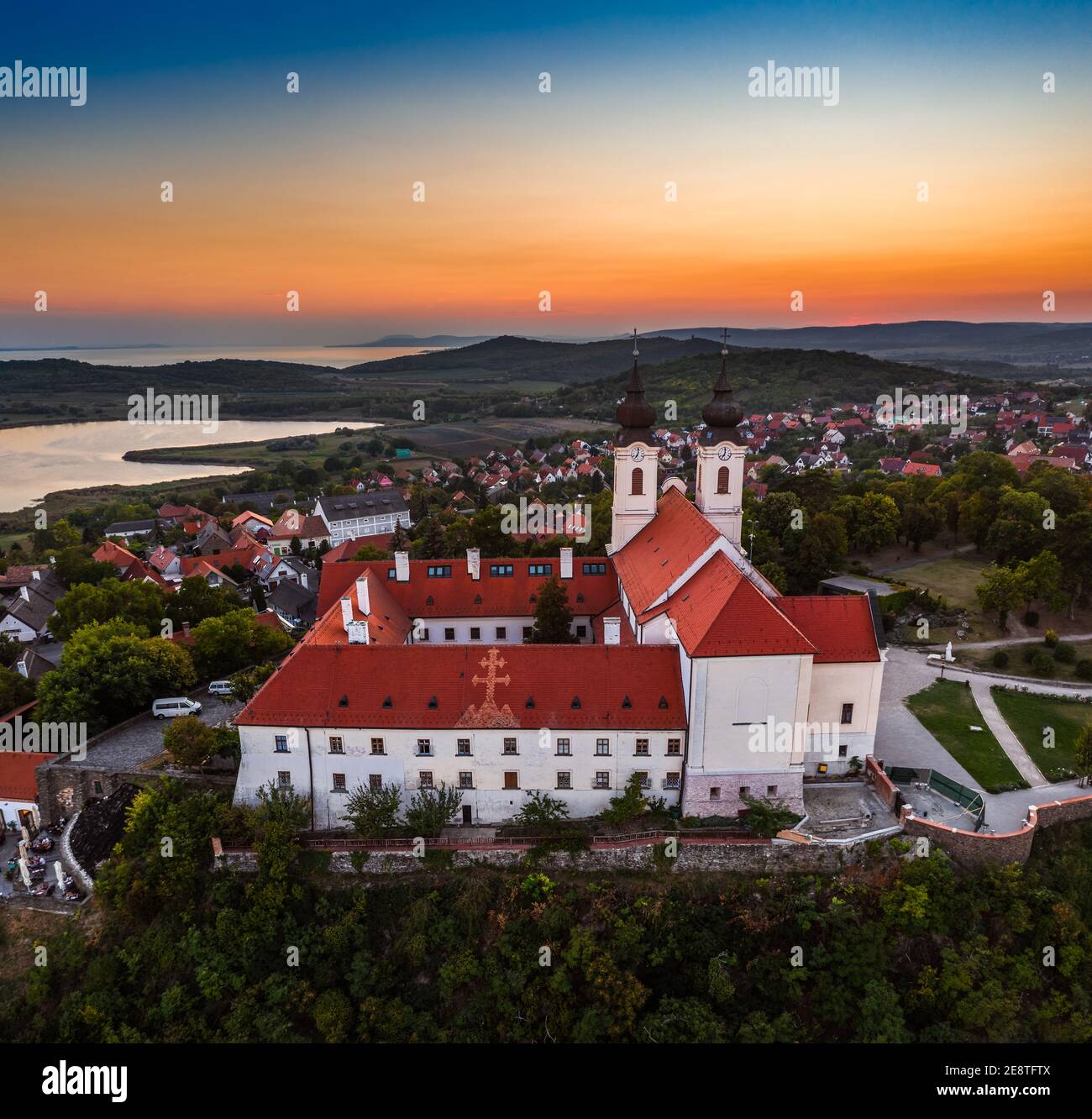 Tihany, Hungary - Aerial view of the famous Benedictine Monastery of Tihany (Tihany Abbey, Tihanyi Apatsag) with beautiful golden sky at sunset over L Stock Photo