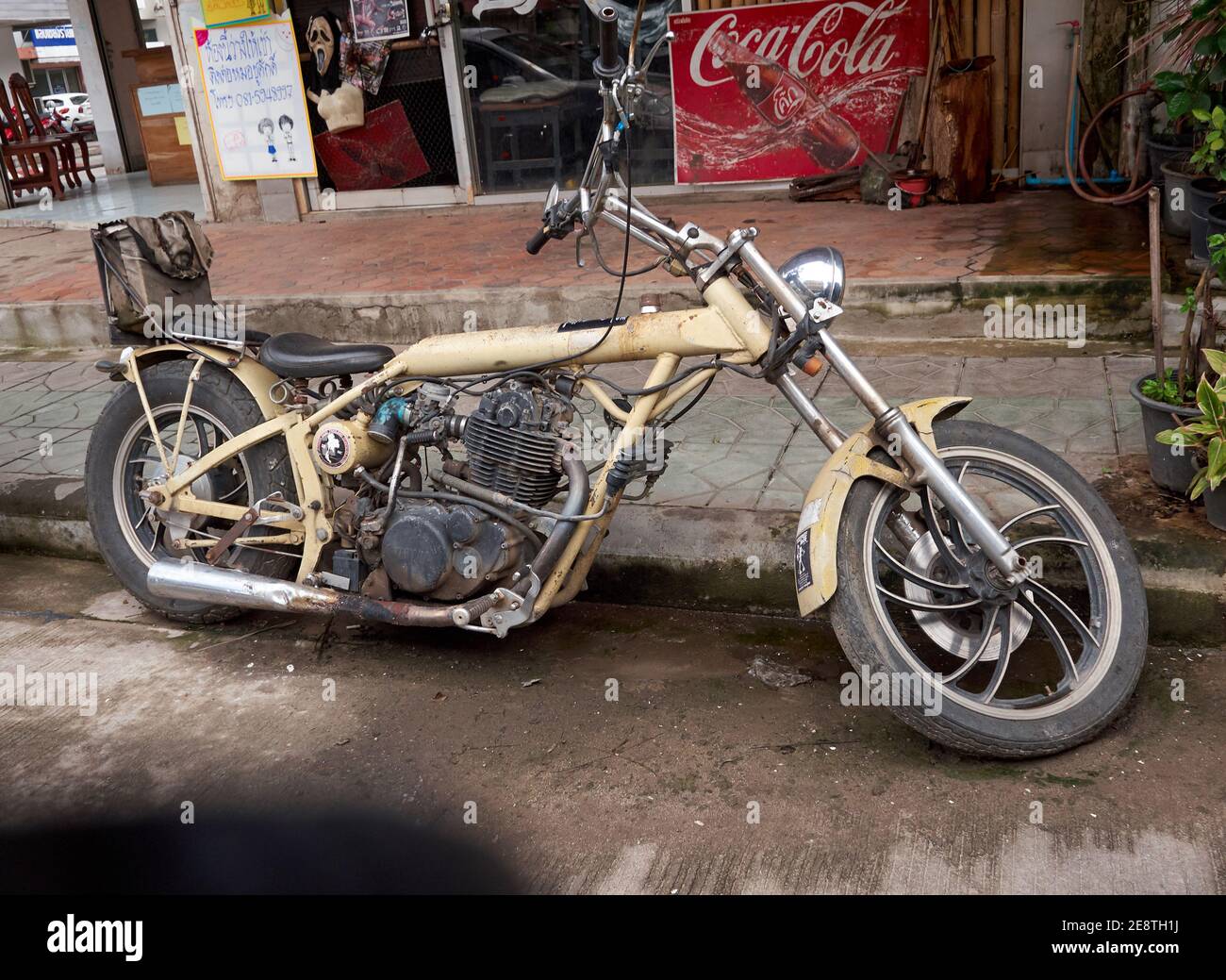 A unique and rare modified motorcycle parked by the side of the road Stock Photo