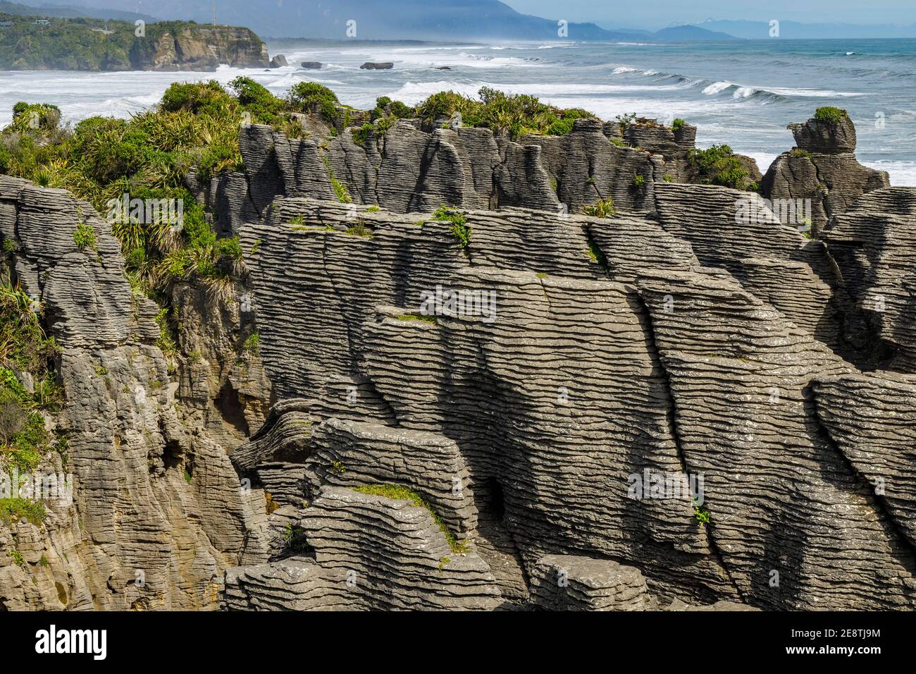Pancake Rocks at Punakaiki, South Island, New Zealand. The heavily eroded limestone area creates the layered rock formations and blow holes. Stock Photo
