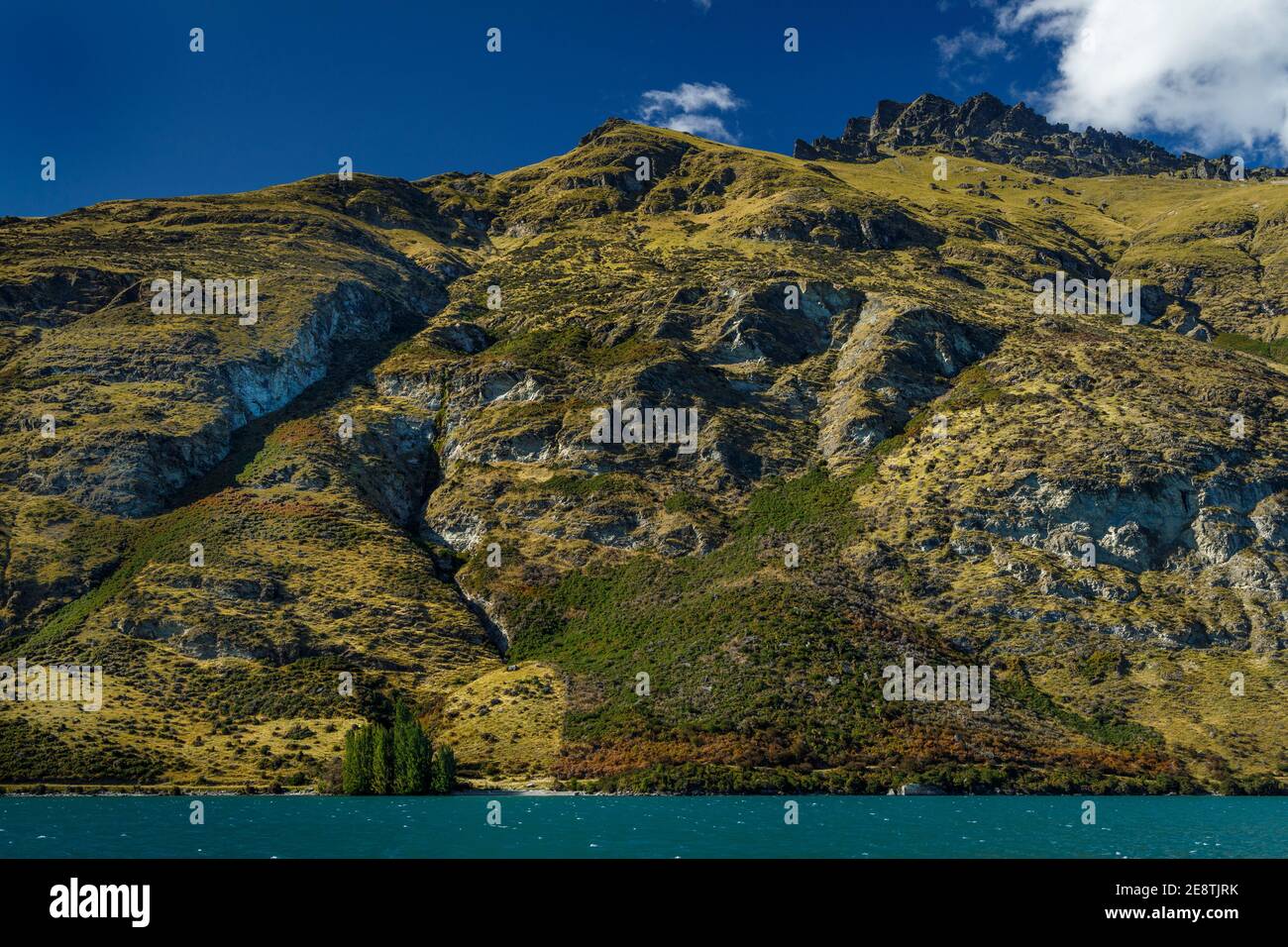 The mountains and hillsides along Lake Wakatipu in Queensland, South Island, New Zealand. Stock Photo