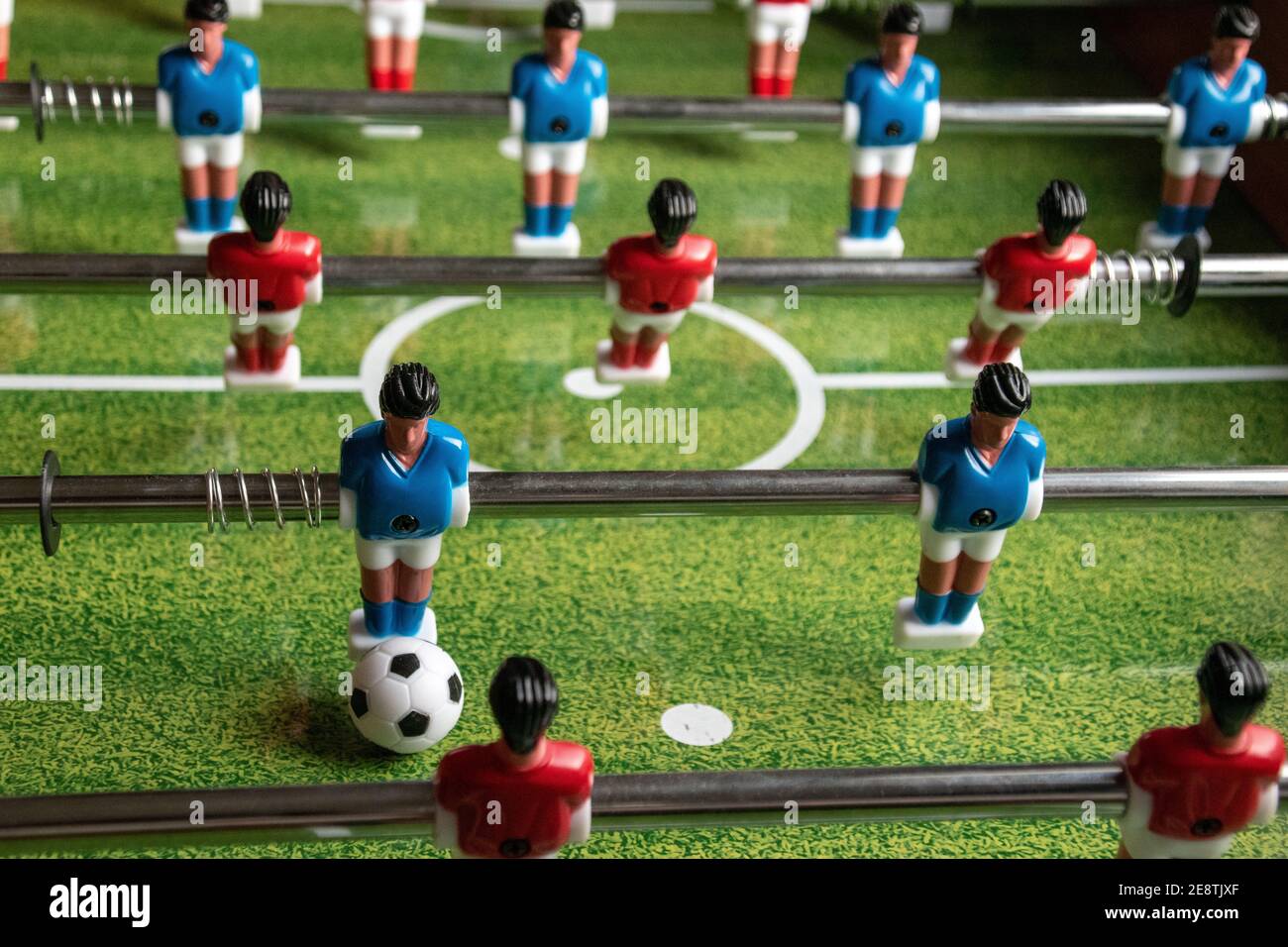 Table football, also known as table soccer, or foosball, with blue and ...