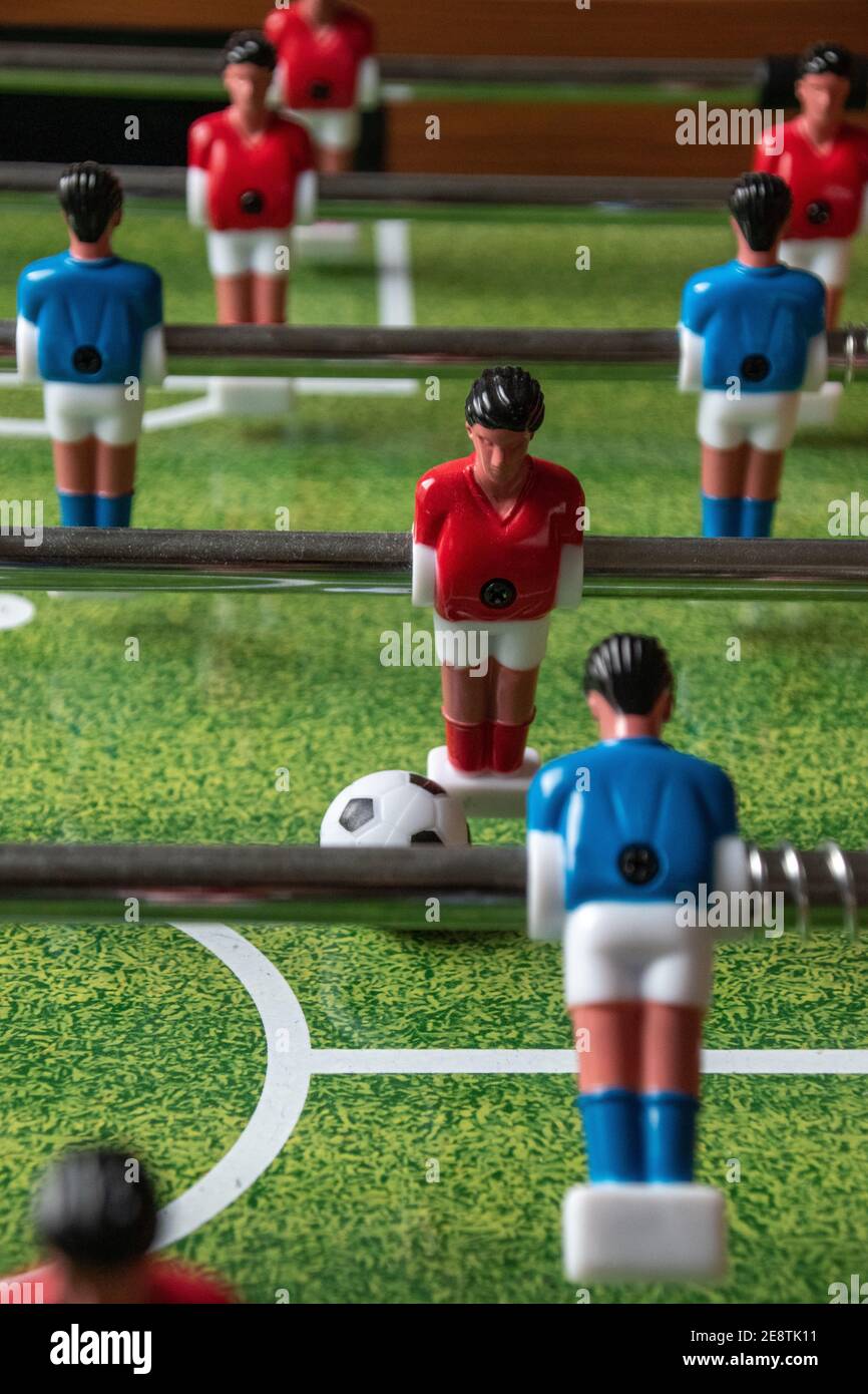 Table football, also known as table soccer, or foosball, with blue and ...