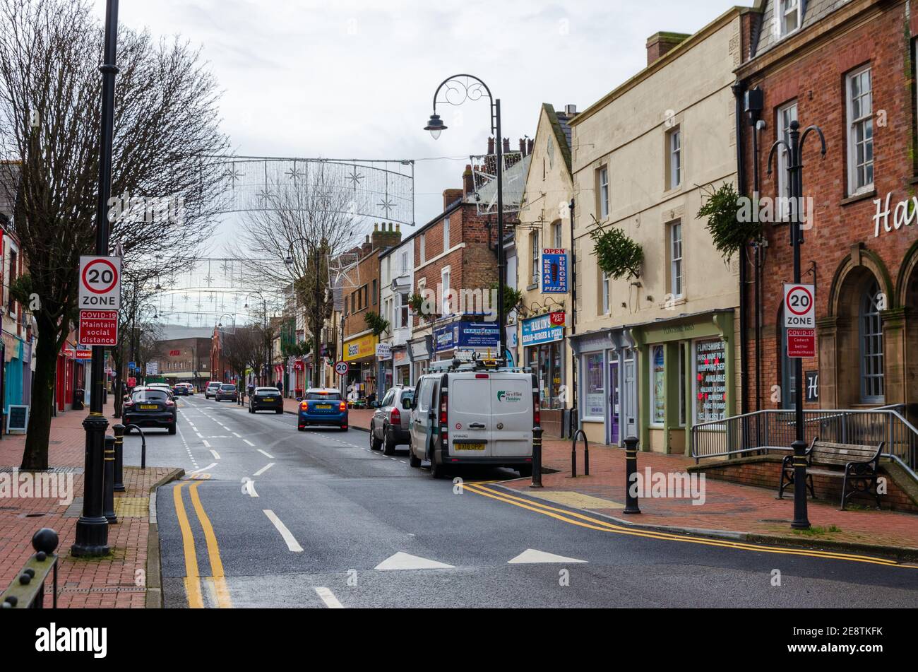 Flint; UK: Jan 28, 2021: The High Street is very quiet on a Thursday afternoon as non-essential shops and businesses remain closed during the pandemic Stock Photo