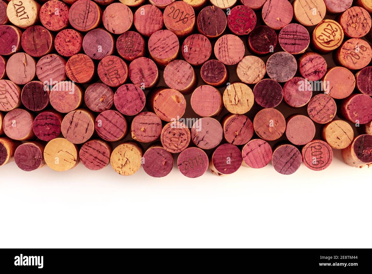 Wine corks background, shot from above with copy space, a design template for a restaurant menu or winery, on a white background Stock Photo