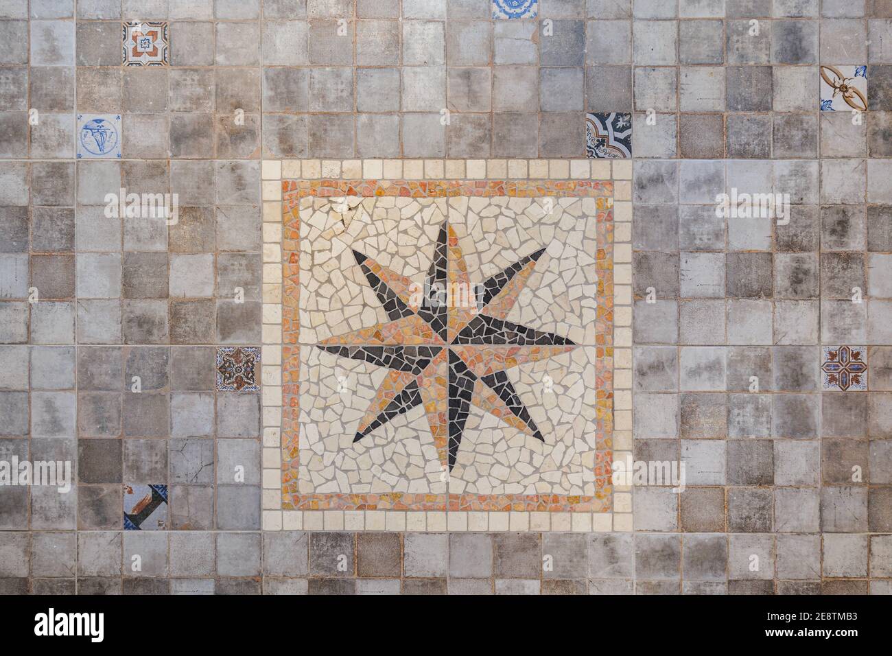 Decorative gray floor tiles with big eight-pointed star in center ...