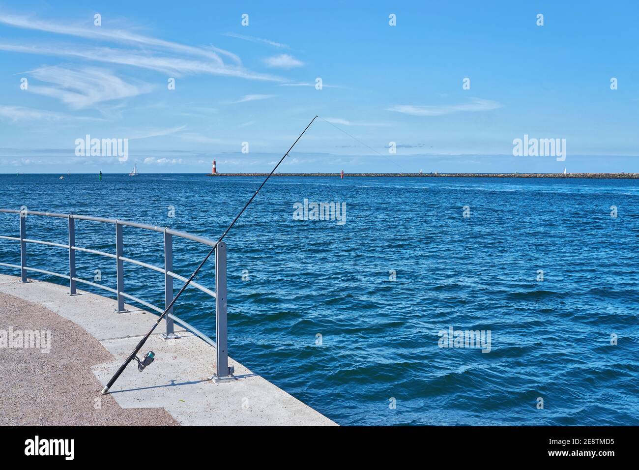 Fishing rod on the blue Baltic Sea in Warnemünde. Stock Photo