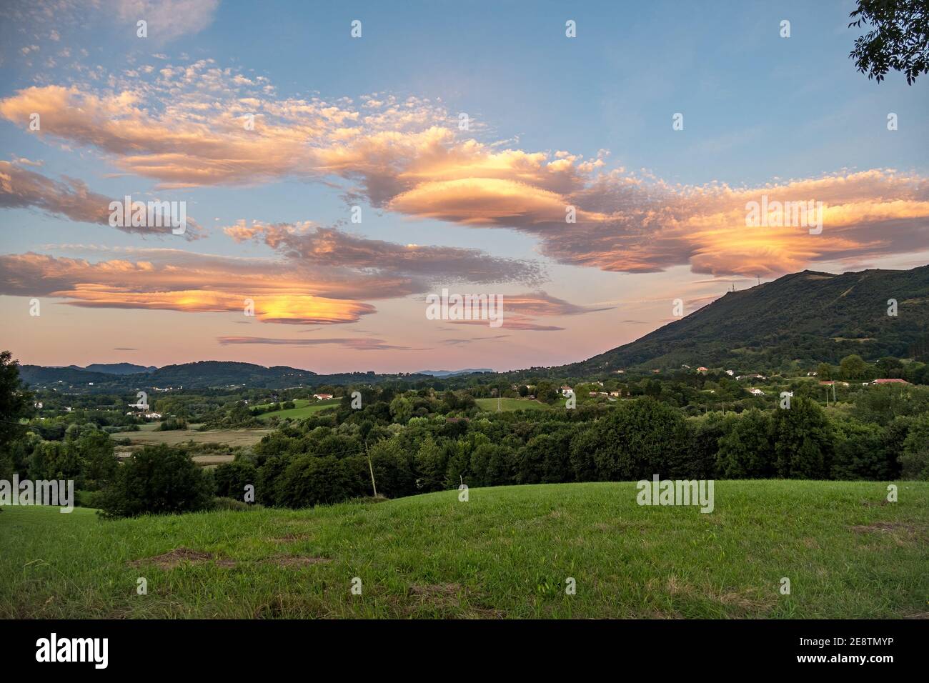 Amazing colorful lenticular clouds over mountain in countryside. Irun, Basque Country, Spain. Stock Photo