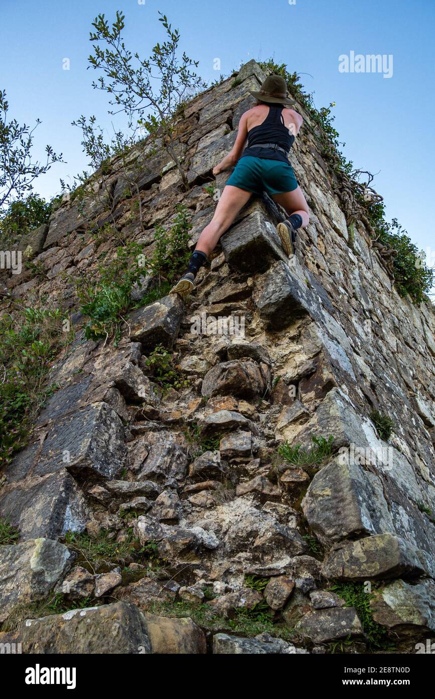 Woman rock climbing without equipment hires stock photography and