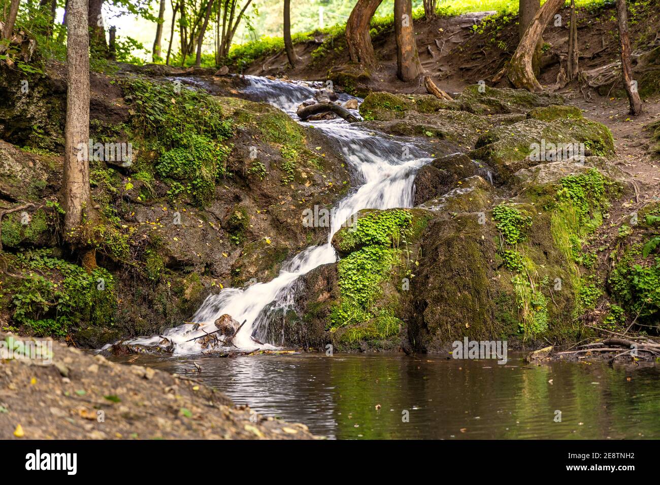 Waterfall Szum on Bentkowka Creek in Bedkowska Valley within Jura Krakowsko-Czestochowska upland near Cracow in Lesser Poland Stock Photo