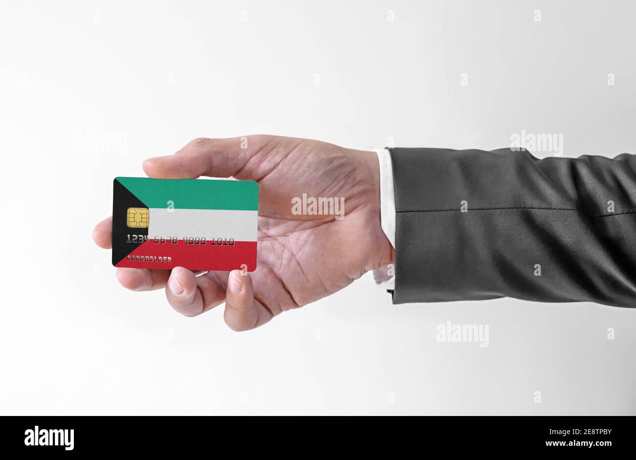 Bank credit plastic card with flag of Kuwait holding man in elegant suit Stock Photo Alamy