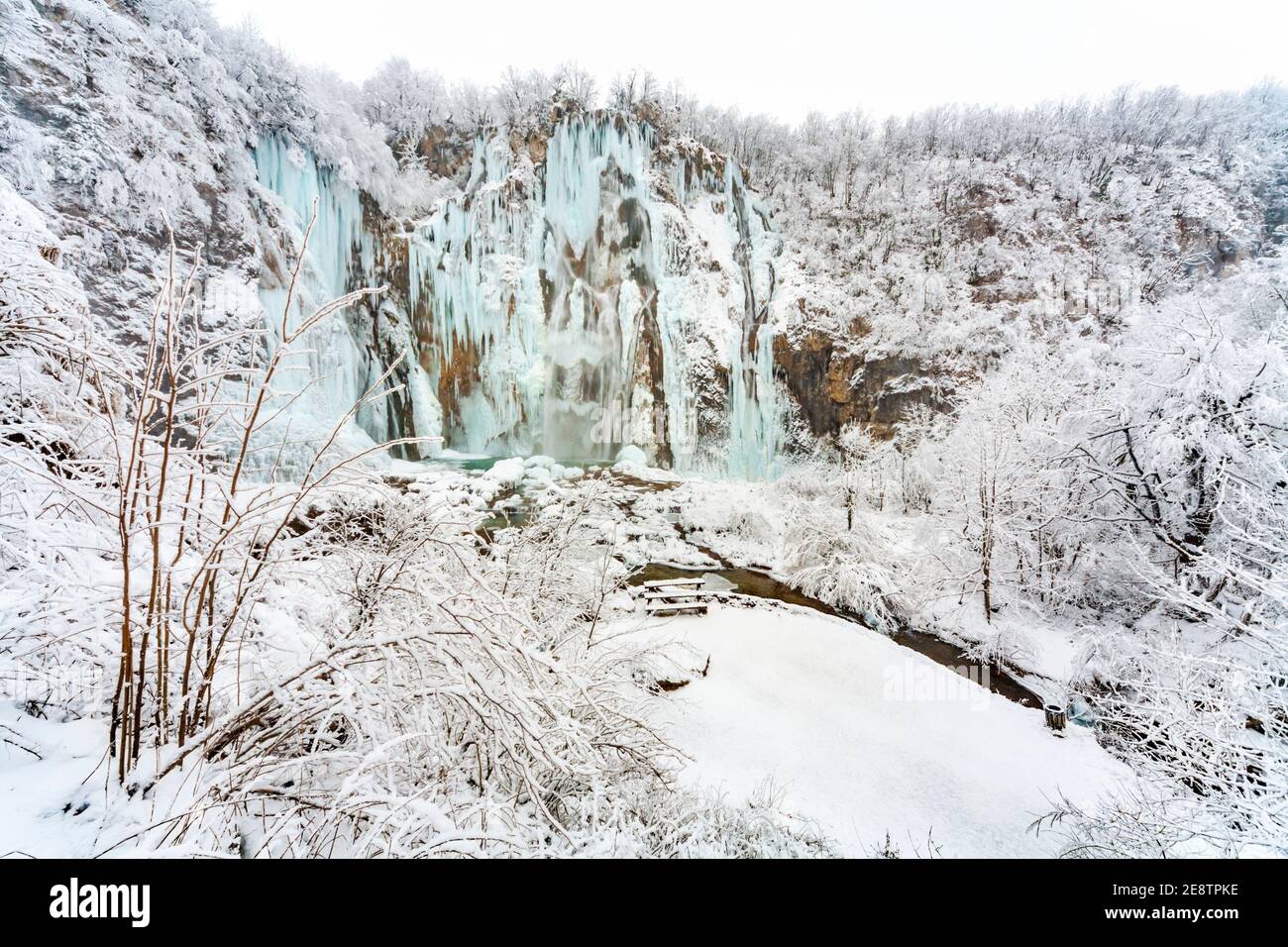 Frozen Veliki slap waterfall in national park Plitvice lakes in Croatia Europe in Winter under covered cover snow and ice Stock Photo