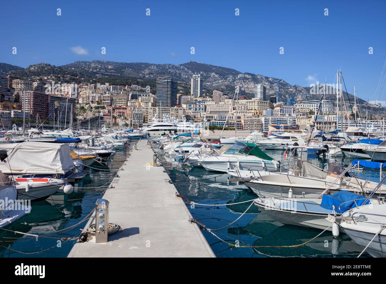 Monaco principality cityscape, pier with boats and yachts at Port Hercule in the Mediterranean Sea, view to Monte Carlo Stock Photo