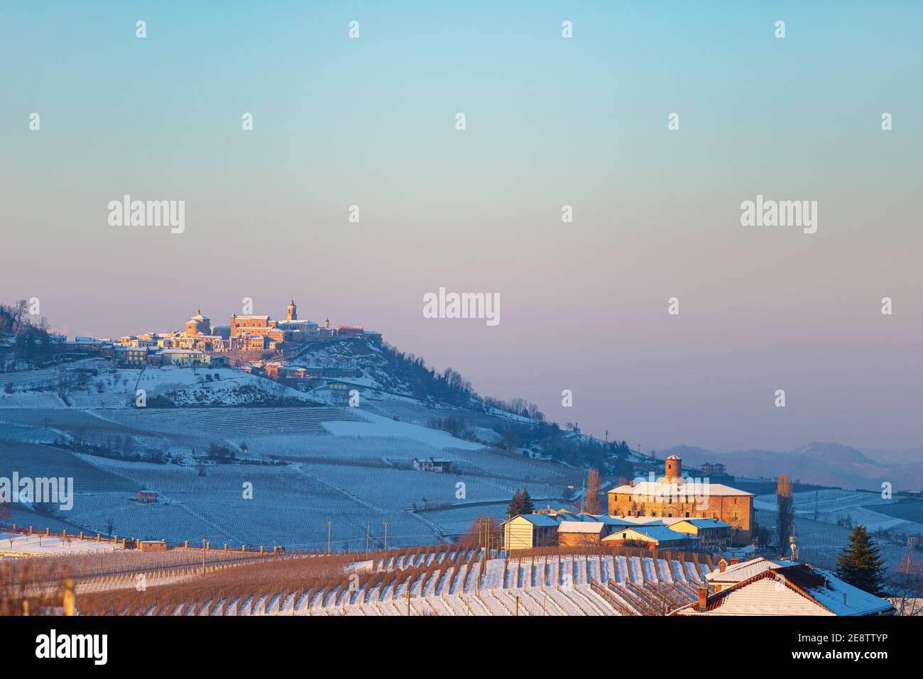 Italy Piedmont: wine yards unique landscape winter, La Morra village perched on hill top, sunset dramatic sky background, italian grapes heritage pano Stock Photo