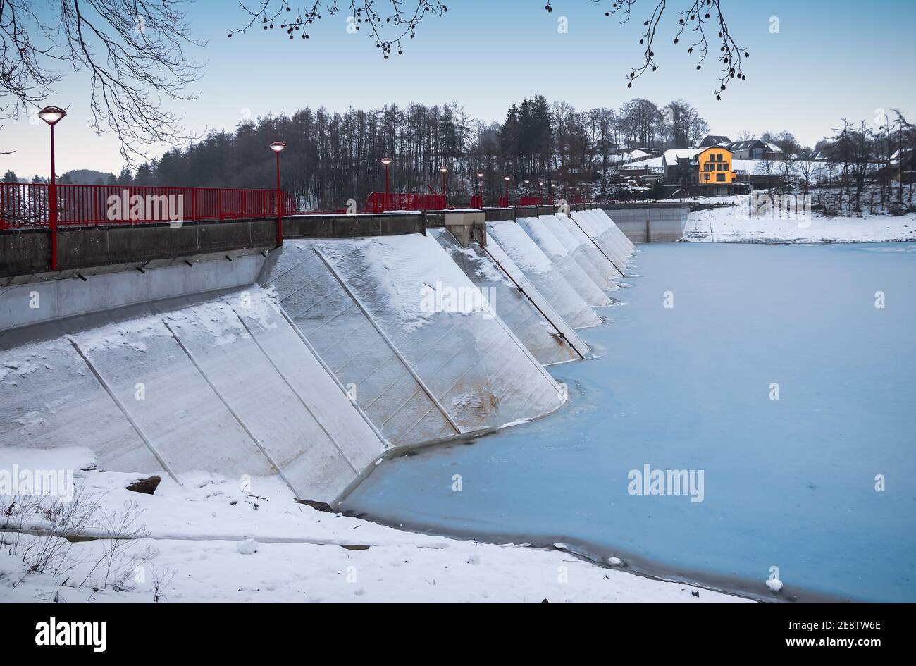 Dam at frozen lake in Bütgenbach, Ardennes, Belgium. Stock Photo