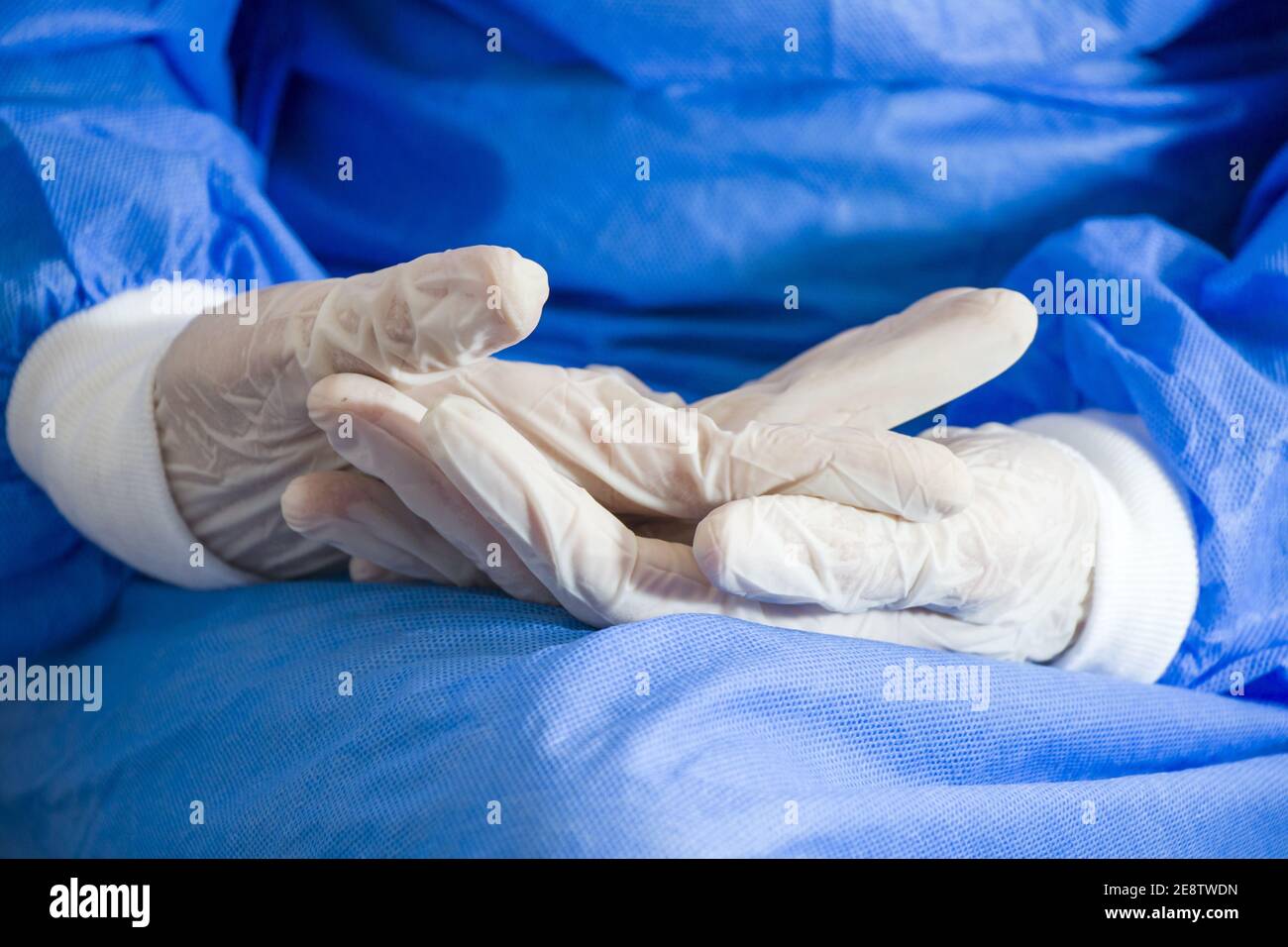 Closeup shot of a doctors hands in white gloves and in surgery uniform