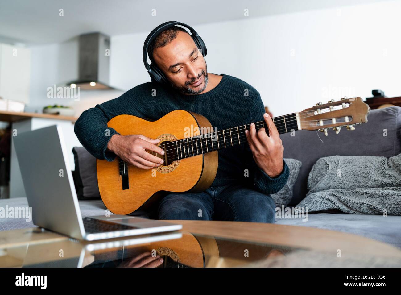 40 years old man learning the guitar with online lessons at home Stock  Photo - Alamy