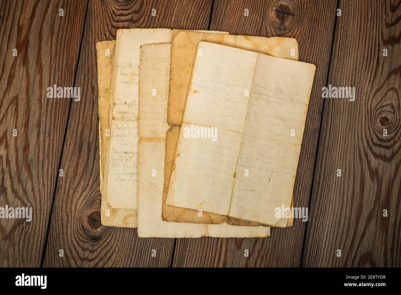 Old sheets stacked on wood background Stock Photo