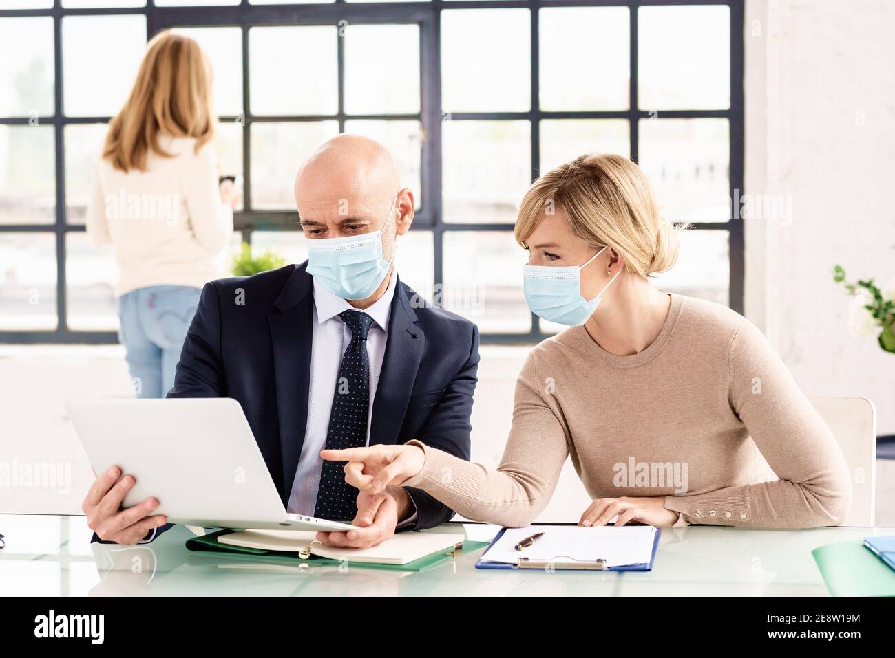 Group of business people wearing face masks while working together in ...