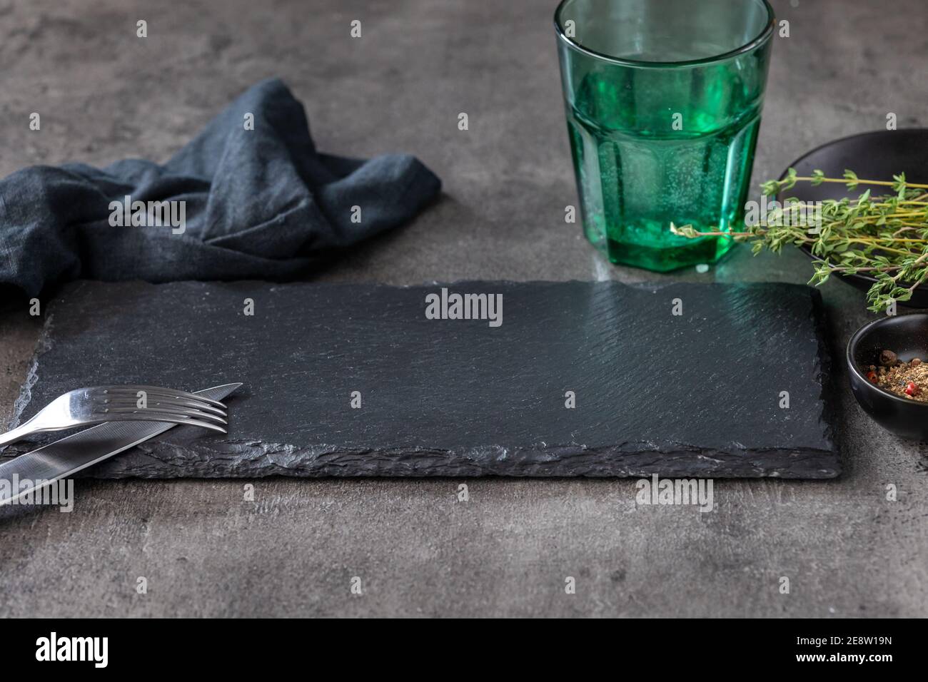 empty black stone plate on black restaurant table Stock Photo