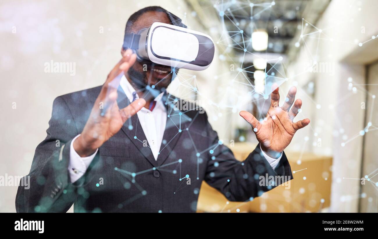 African entrepreneur with VR glasses uses virtual reality in factory as ...