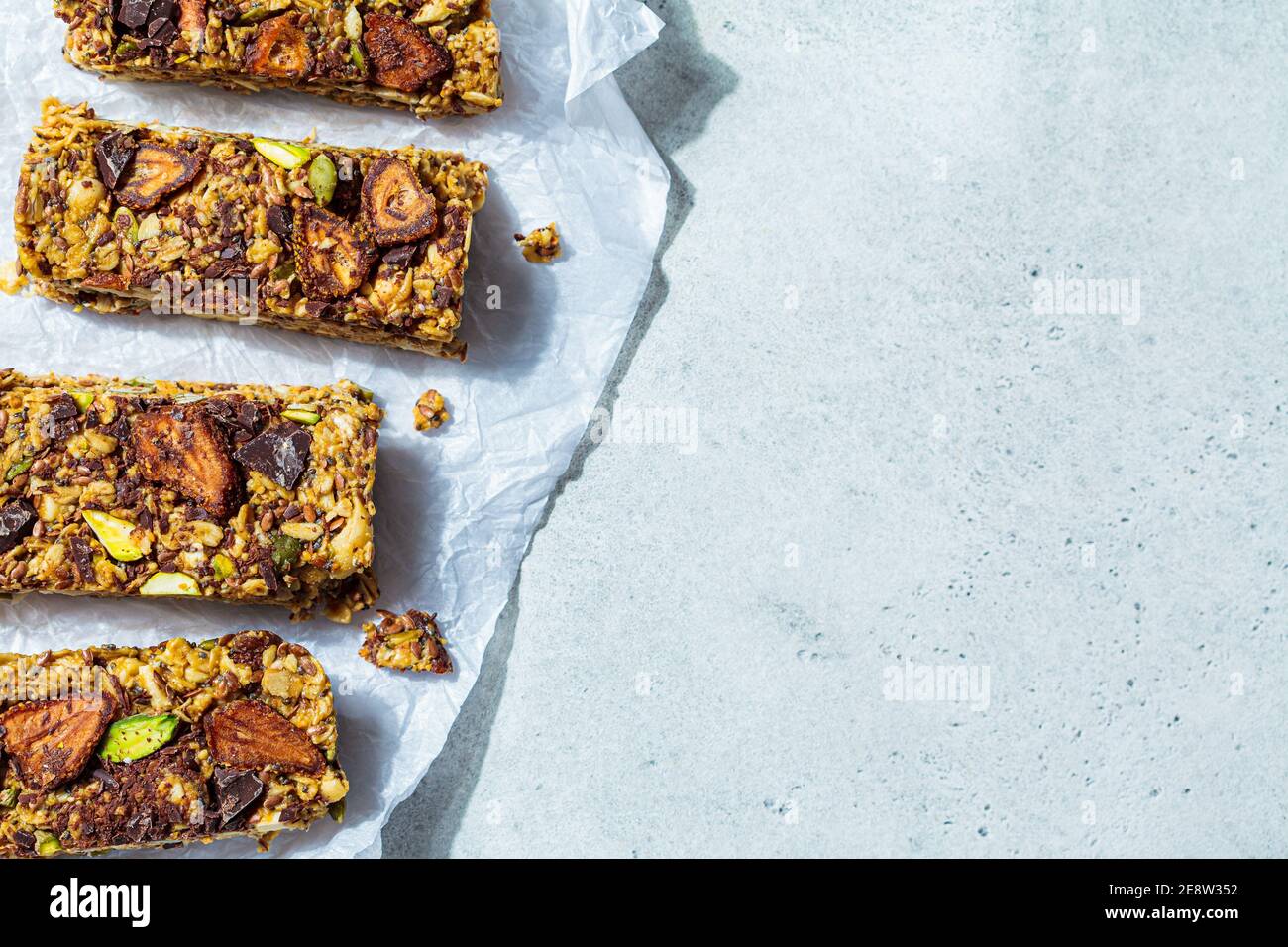 Homemade oat bars with berries and nuts, light background. Energy