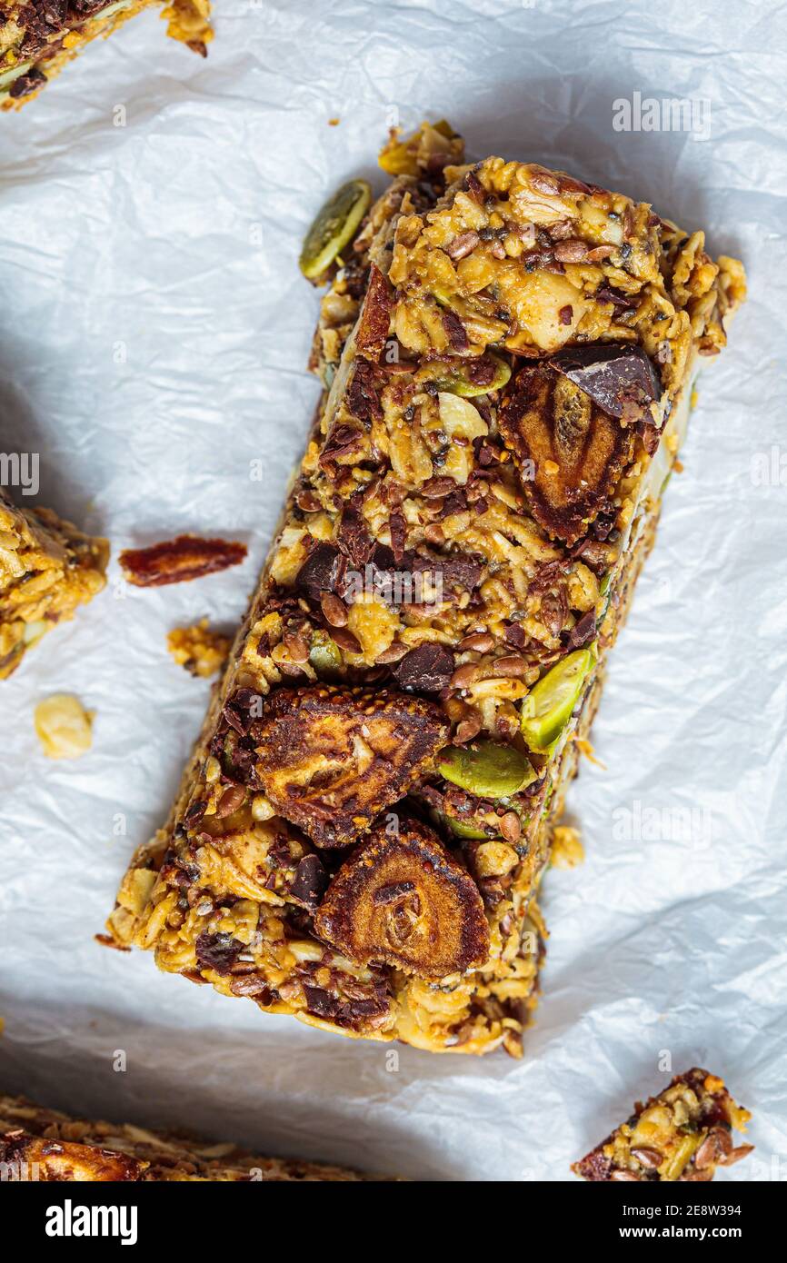 Homemade oat bars with berries and nuts, light background. Energy