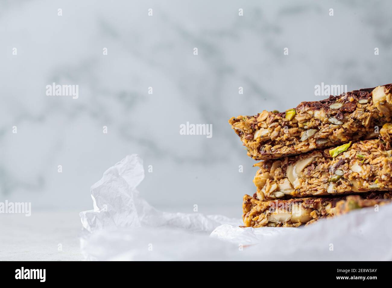 Homemade oat bars with berries and nuts, light background. Energy Protein Healthy Bars. Vegan dessert concept. Stock Photo