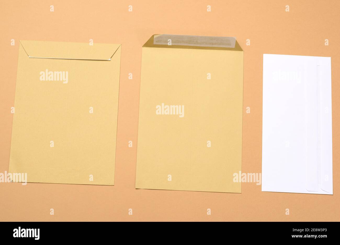 blank white paper brown and white envelopes on a brown background, top