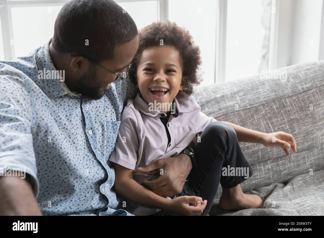 Close up African American father and son hugging, having fun Stock ...