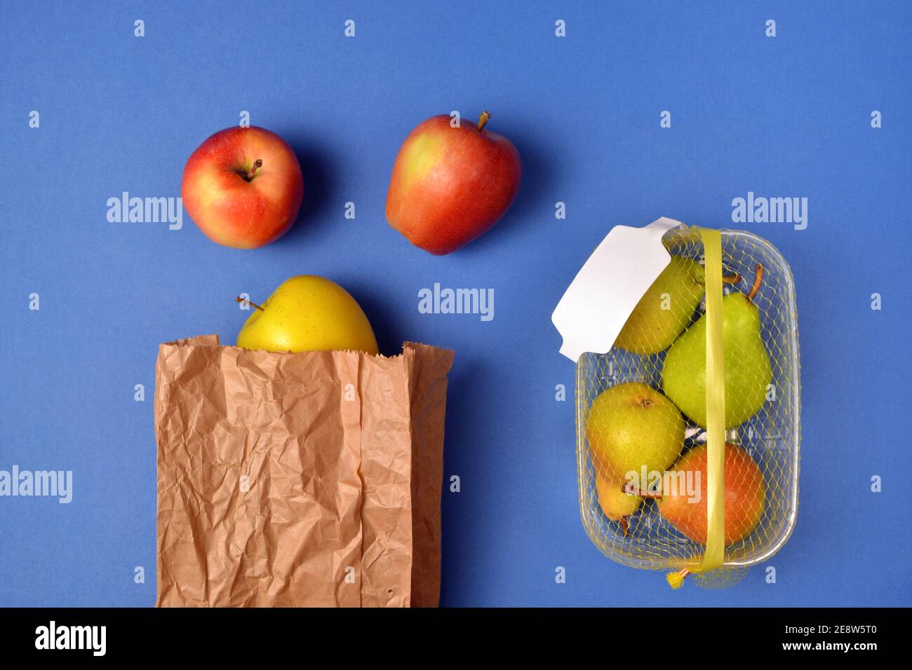 Detail of fruit purchased in plastic packaging and in paper bags Stock Photo