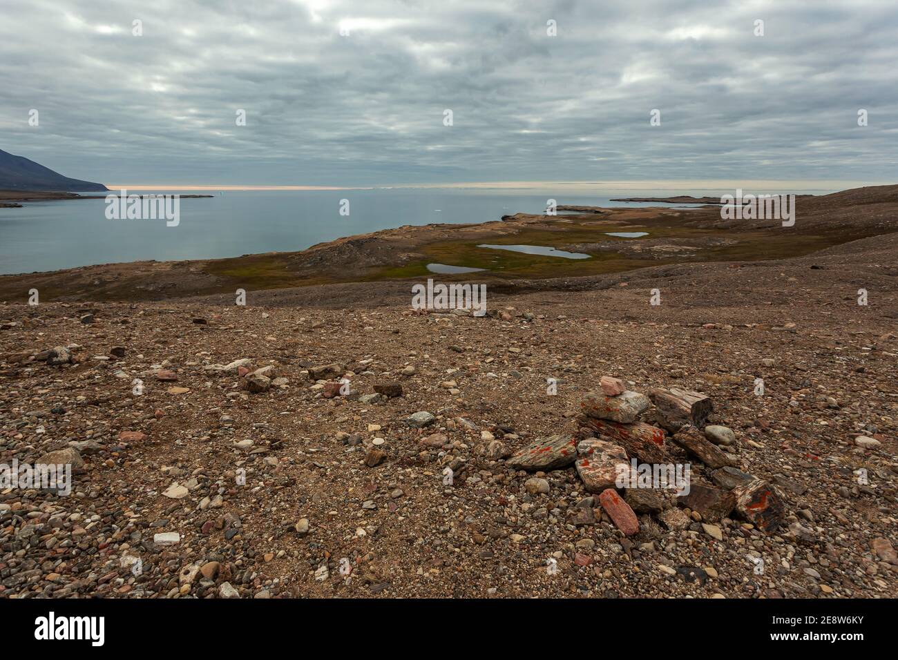 A pile of rocks by Dundas Harbour during a summer day behind the Polar Circle Stock Photo