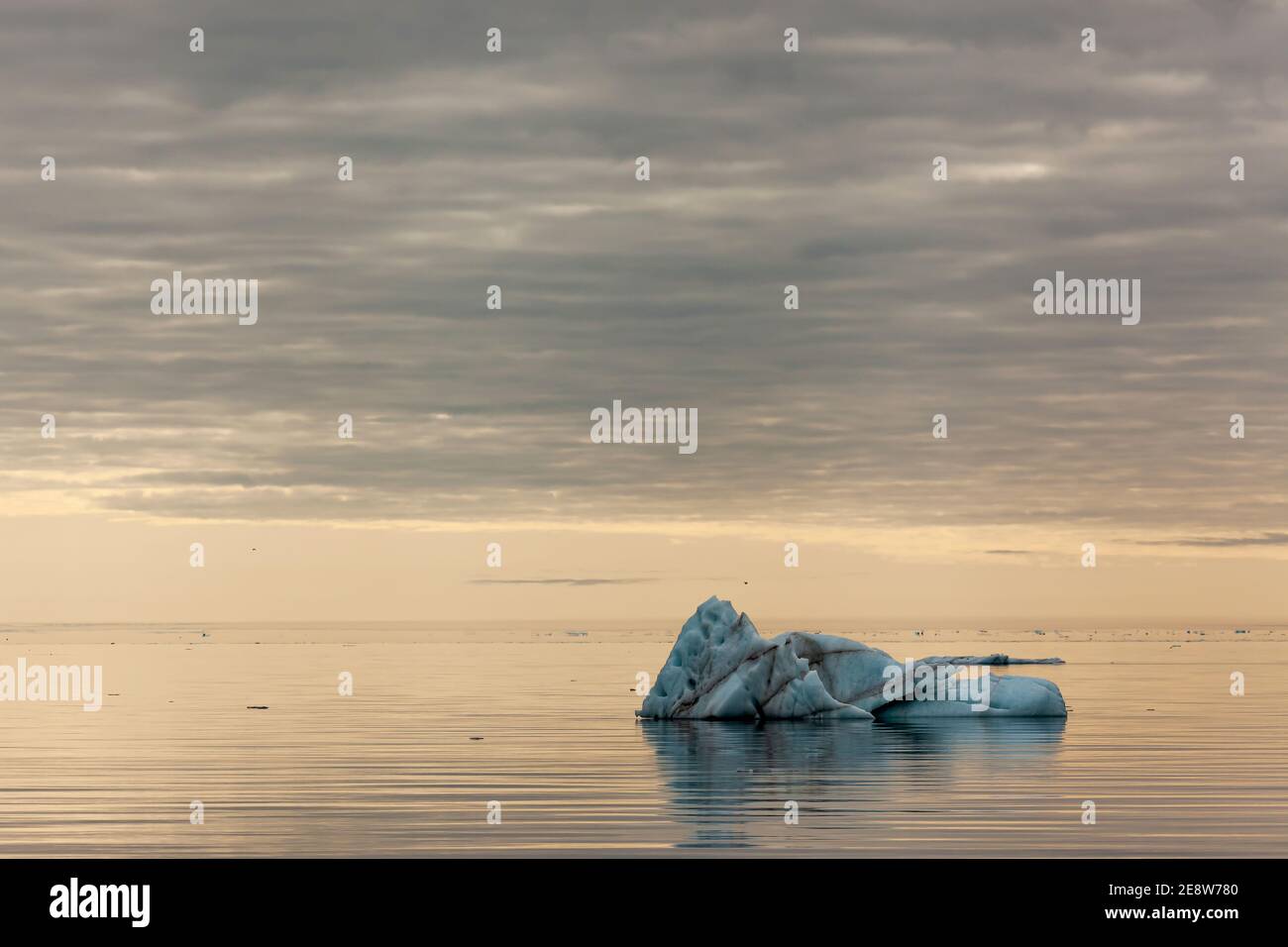 Iceberg floating in sea in Dundas Harbour on a a calm summer day during Midnight Sun Stock Photo