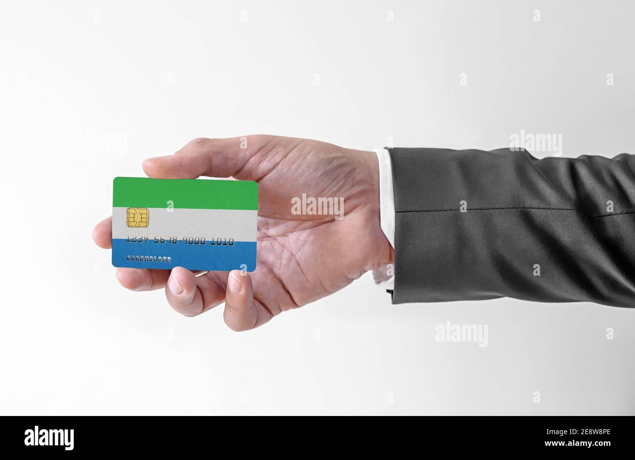 Bank credit plastic card with flag of Sierra Leone holding man in elegant suit Stock Photo